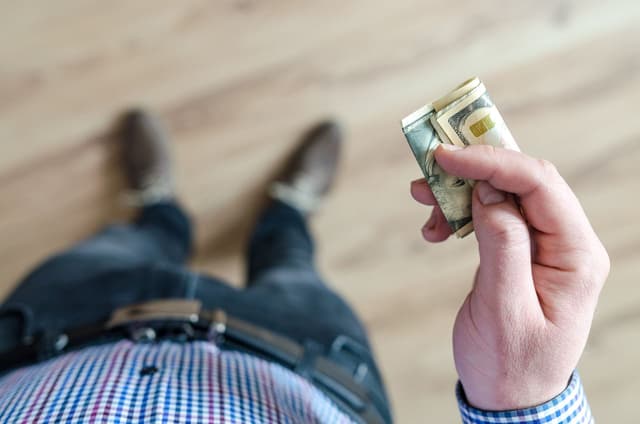 Man holding a $10 bill