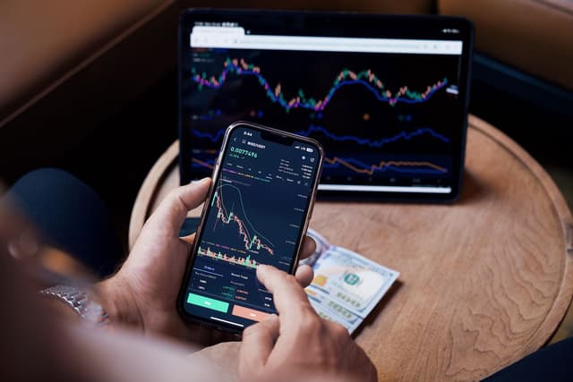 A person looking at stock charts while considering investing for stagflation