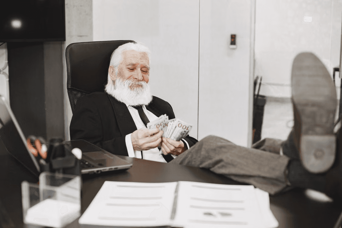 Elderly man counting cash instead of focusing on retirement security