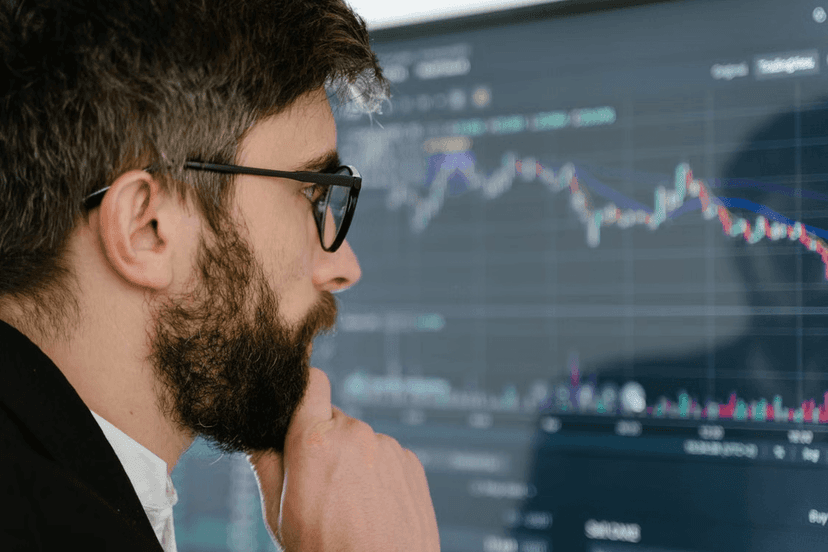 Investor analyzing a volatile financial chart and considering the benefits of low-risk investing