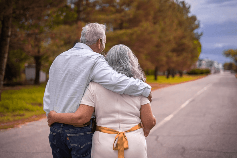 Elderly couple walking down a road