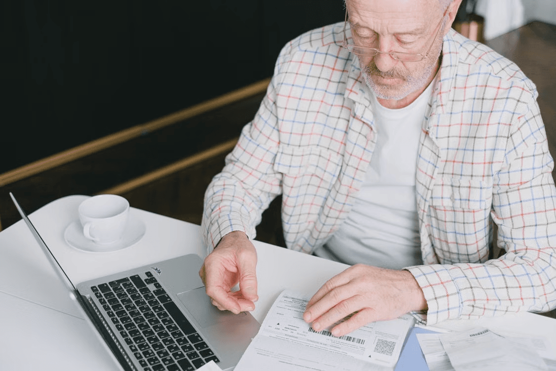 Elderly man reviewing retirement savings documents